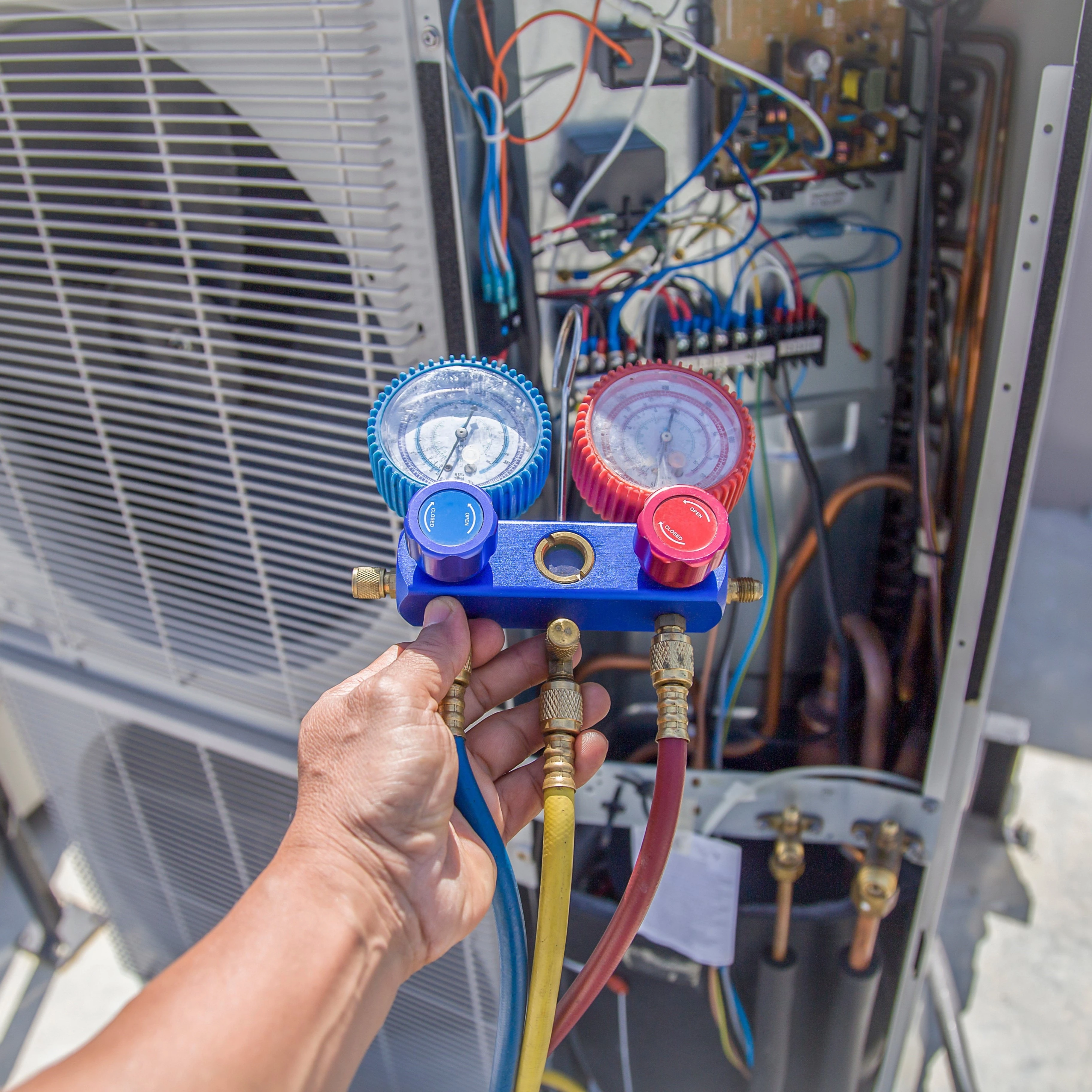 A technician services an outdoor HVAC unit, a key part of the AC installation process in Bixby.